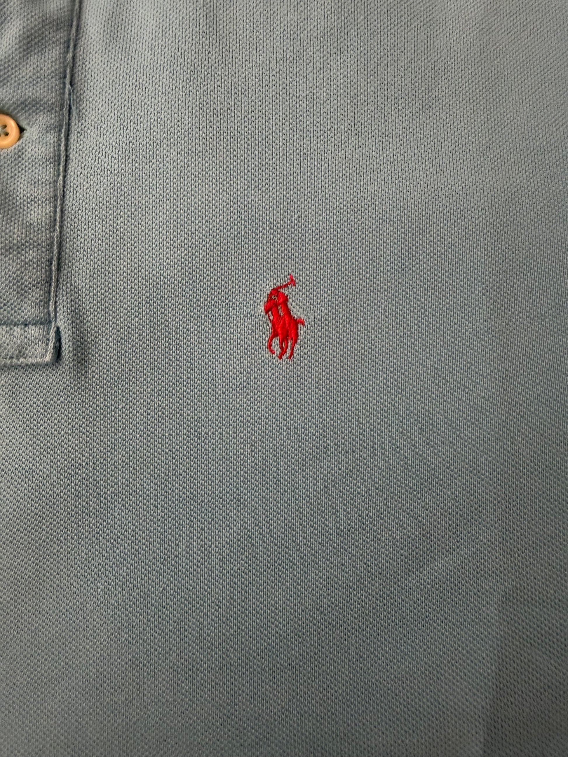 Vintage Polo Ralph Lauren men's light blue button-up polo shirt with a boxy fit, displayed on a hanger.
