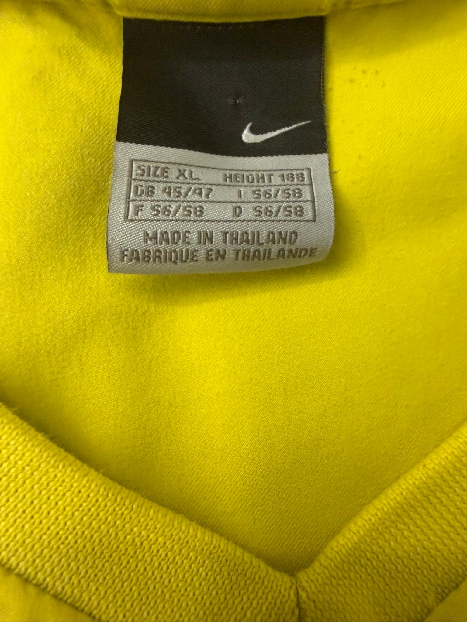Vintage Nike T90 Yellow Brasil football T-shirt from the 2000s, featuring bold graphics and classic sportswear style.