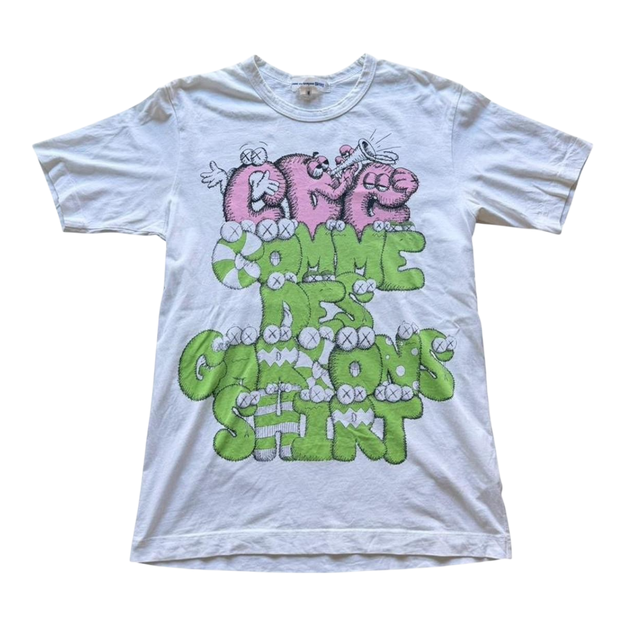 Pink and green graphic T-shirt by Comme des Garçons x KAWS featuring bold artwork, from The Hennessy Archive FW21 collection.