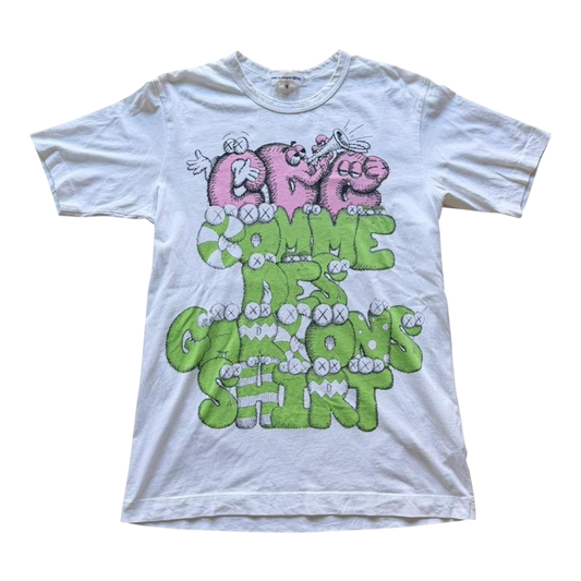 Pink and green graphic T-shirt by Comme des Garçons x KAWS featuring bold artwork, from The Hennessy Archive FW21 collection.