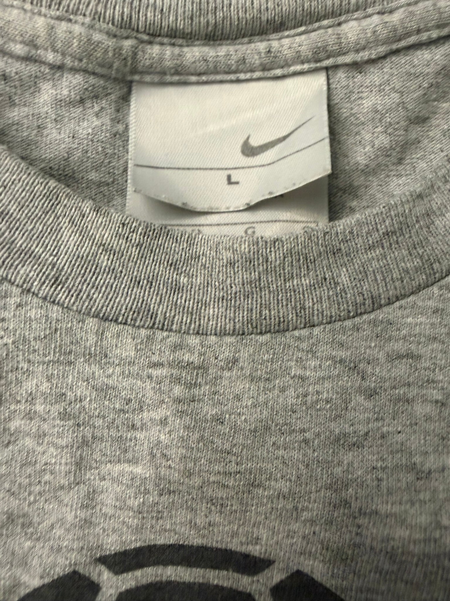 Vintage Nike soccer T-shirt in grey from the 2000s, featuring classic Y2K style, branded by The Hennessy Archive.