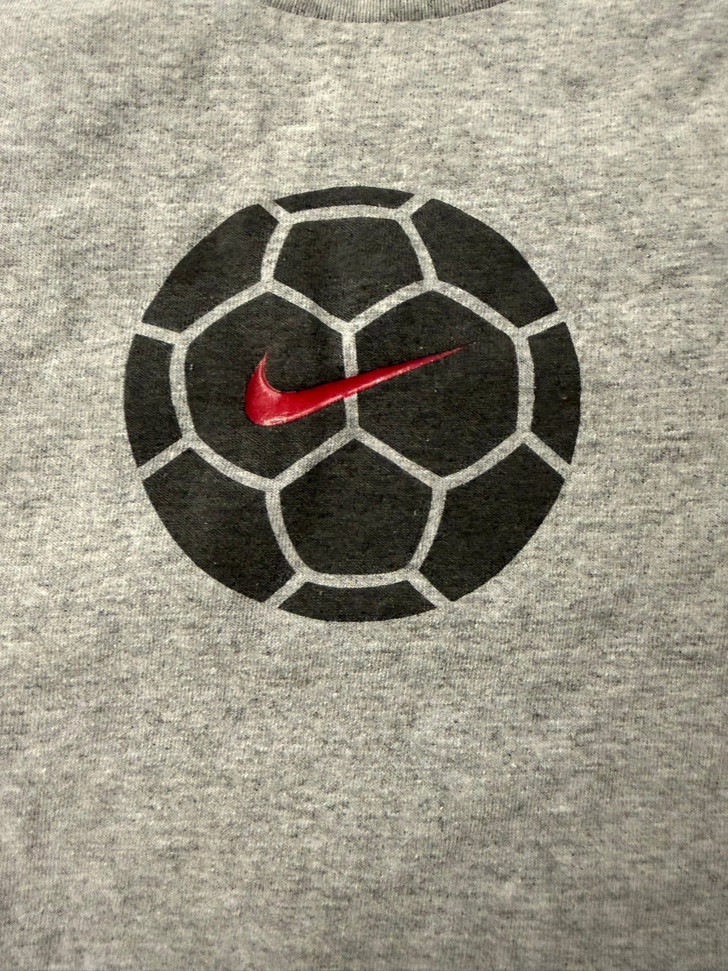 Vintage Nike soccer T-shirt by The Hennessy Archive, Y2K grey 2000s style, featuring classic athletic design and Nike logo.