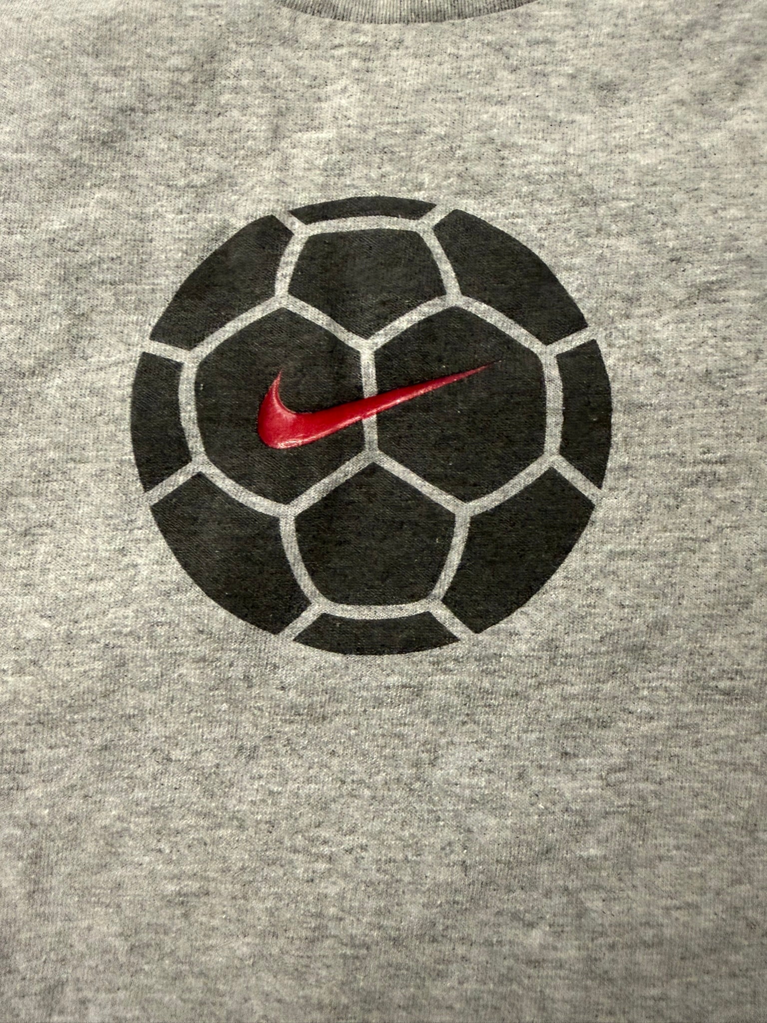 Vintage Nike soccer T-shirt by The Hennessy Archive, Y2K grey 2000s style, featuring classic athletic design and Nike logo.