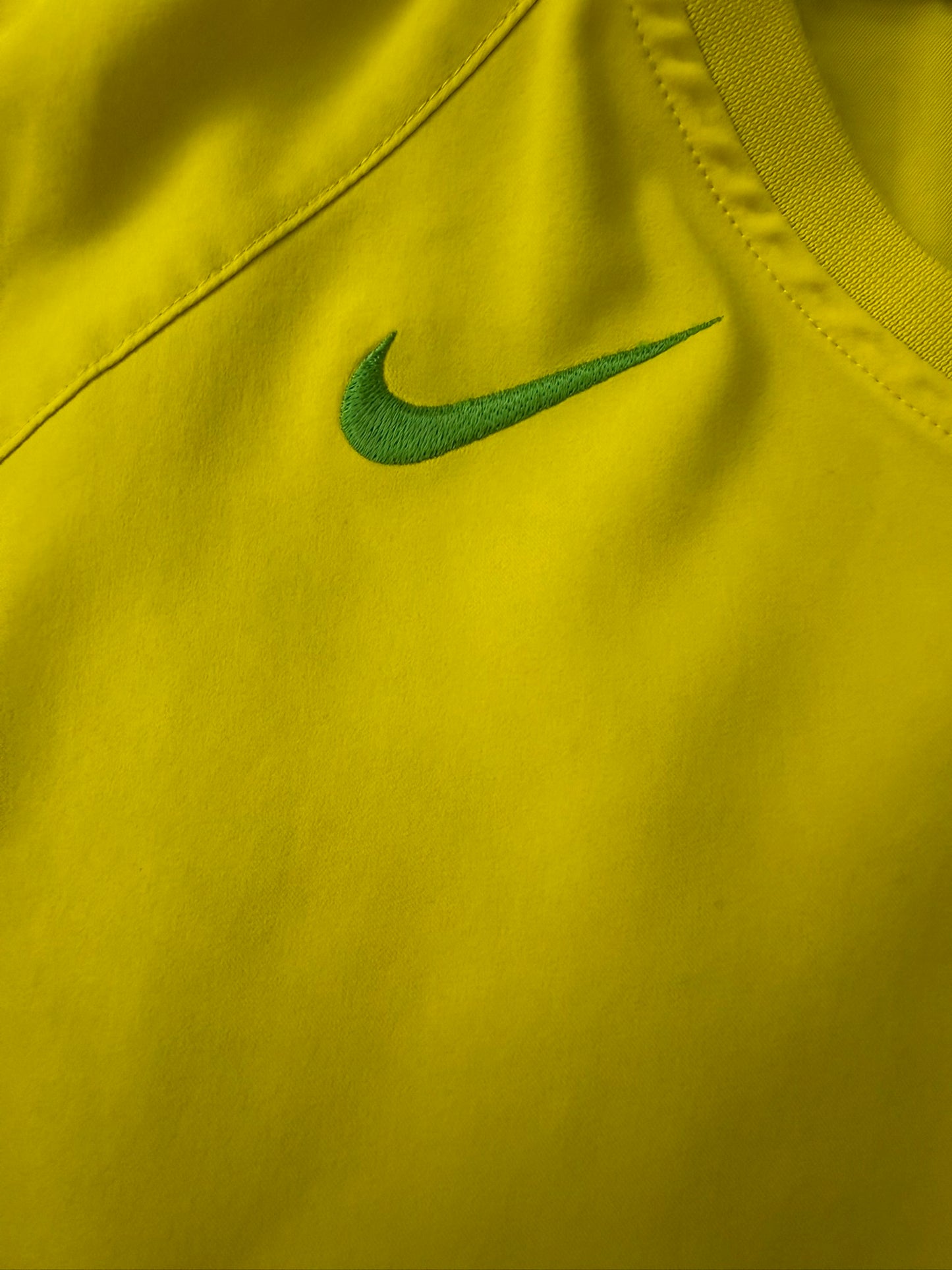 Vintage Nike T90 Yellow Brasil football T-shirt from the 2000s, featuring bold team graphics and classic athletic style.