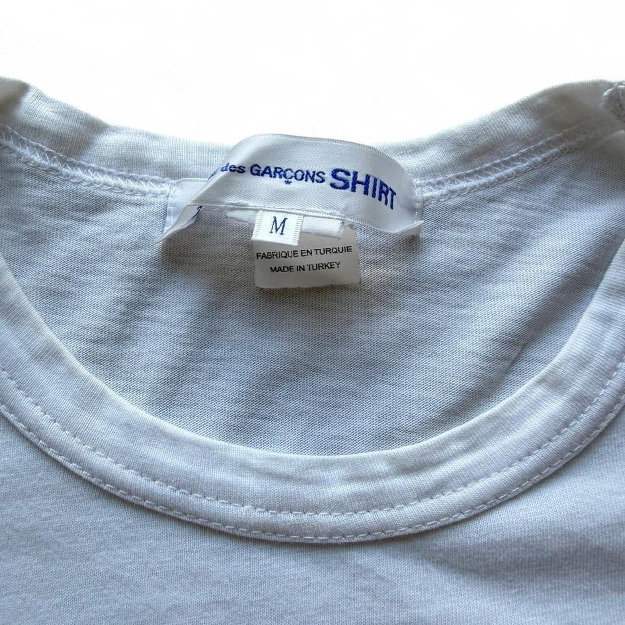 Comme des Garçons x KAWS graphic print T-shirt from The Hennessy Archive, featuring bold artwork on a casual T-shirt.