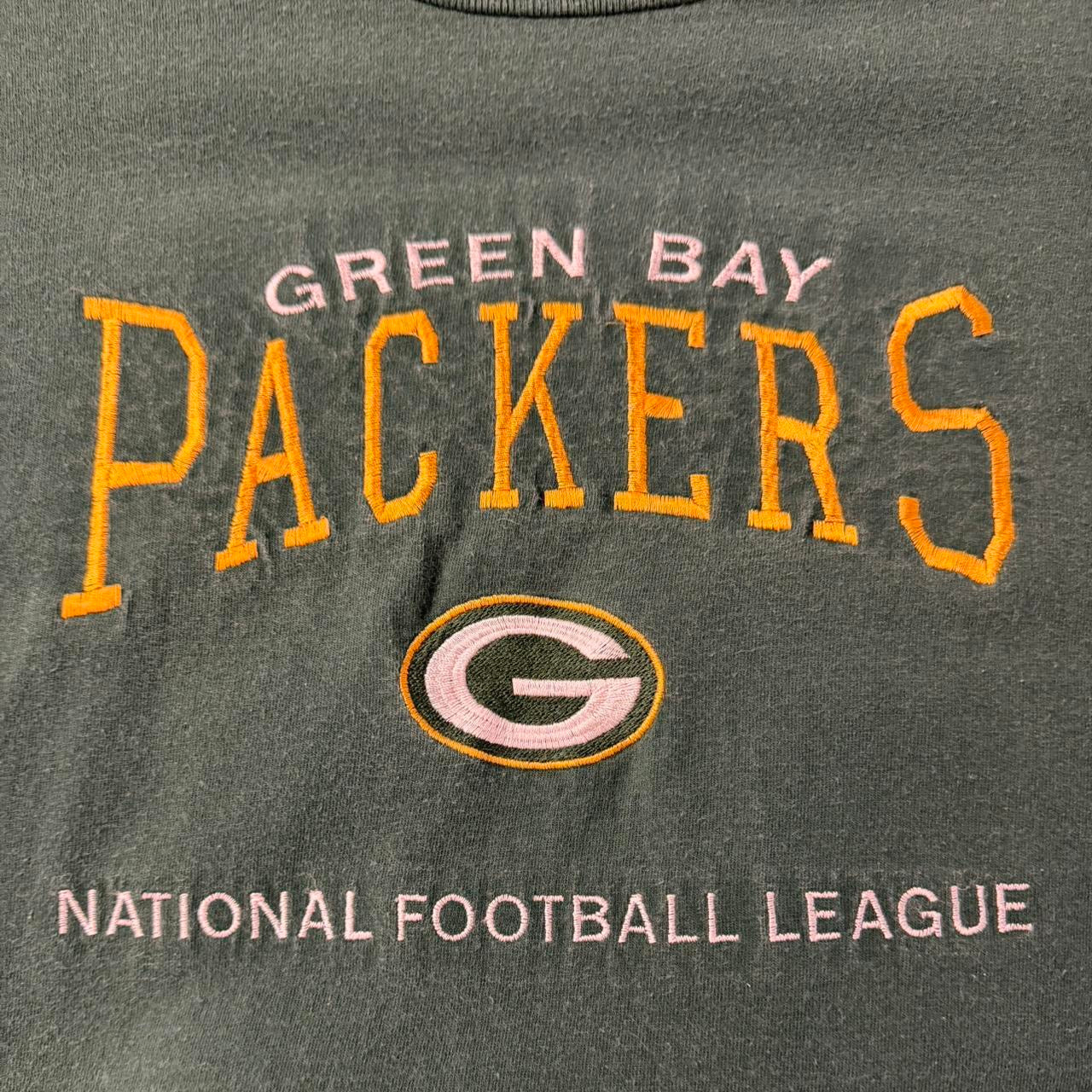 Vintage Green Bay Packers Lee Sport NFL spell out T-shirt featuring green fabric and classic 2000s NFL team branding.
