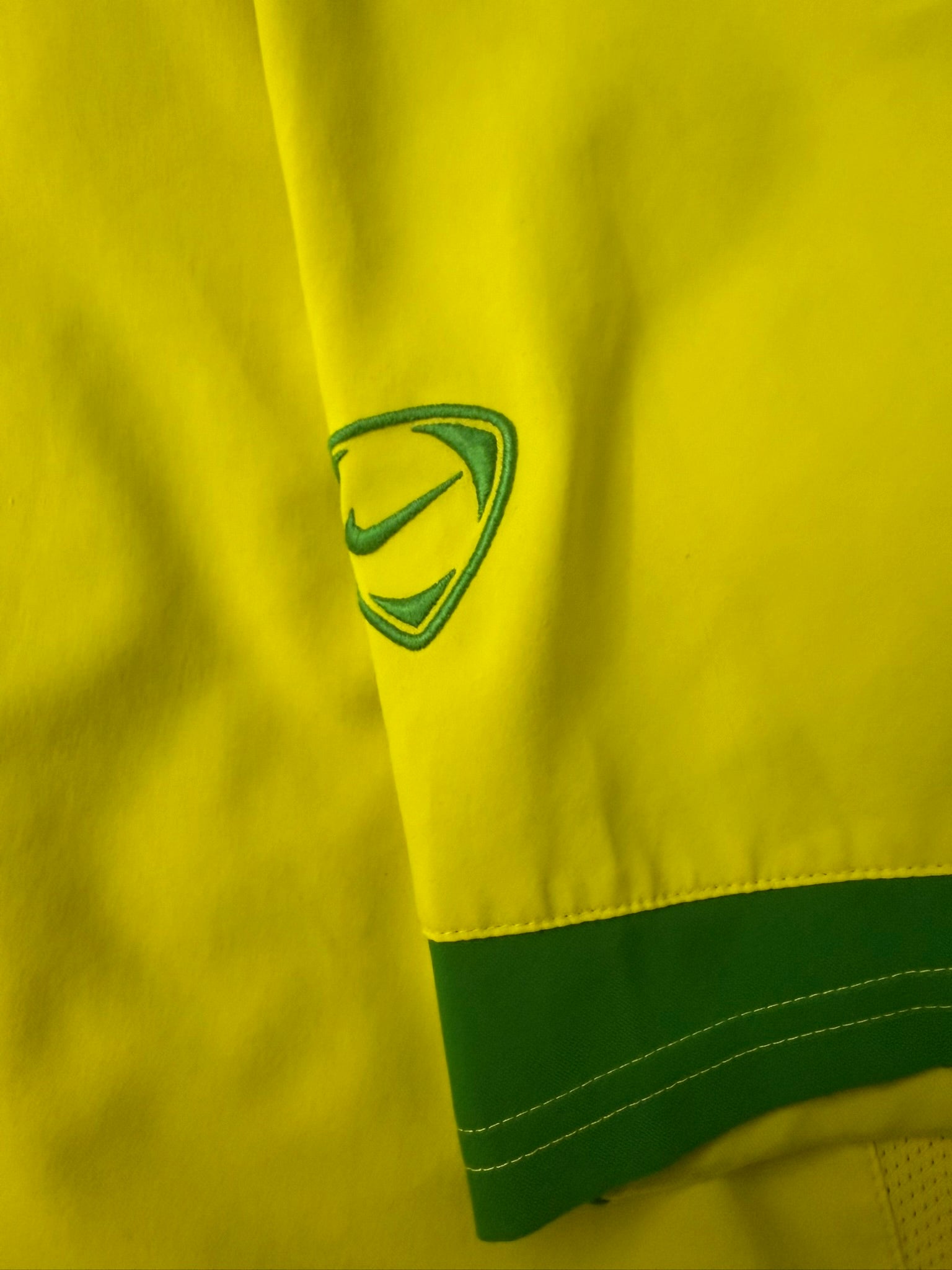 Vintage Nike T90 Yellow Brasil football T-shirt from the 2000s, featuring classic Nike branding and Brazil national team design.