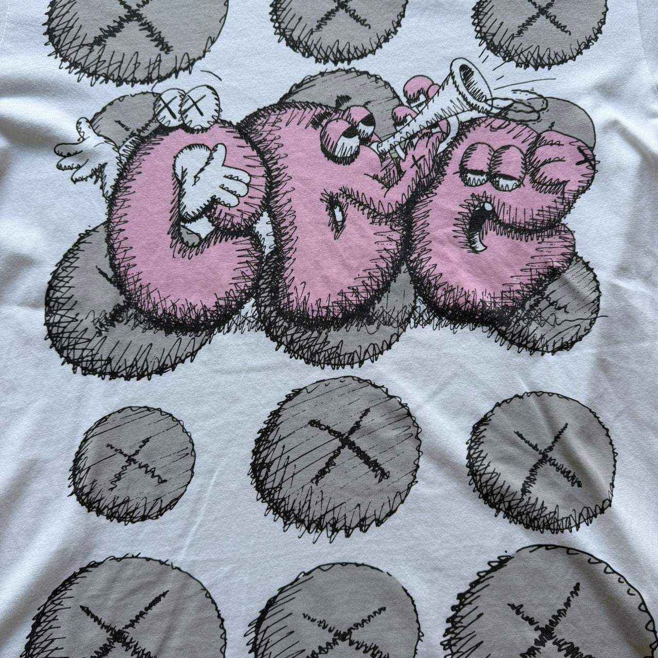 Comme des Garçons x KAWS graphic print T-shirt from The Hennessy Archive, featuring bold artwork on a casual T-shirt.